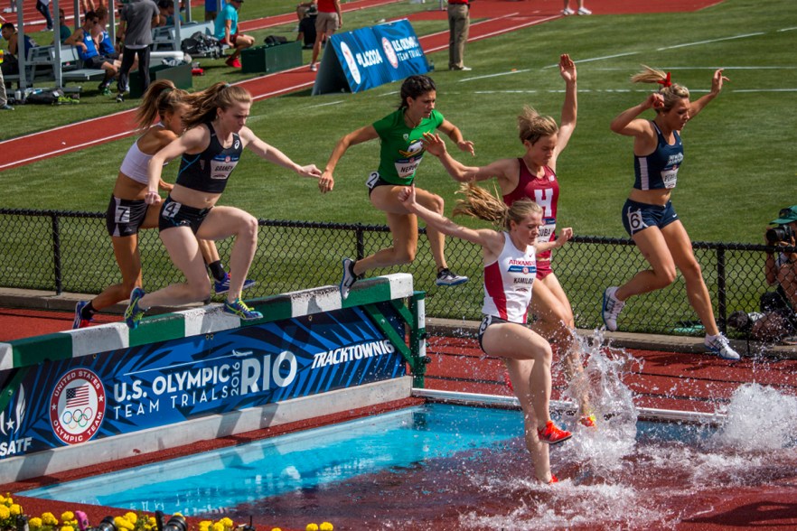 Runners complete a jump over the water obstacle during the women’s 3,000 meter steeplechase. Day Four of the U.S. Olympic Trials Track and Field were held Monday at Hayward Field in Eugene, Ore. and will continue through July 10. Photo by Katie Pietzold