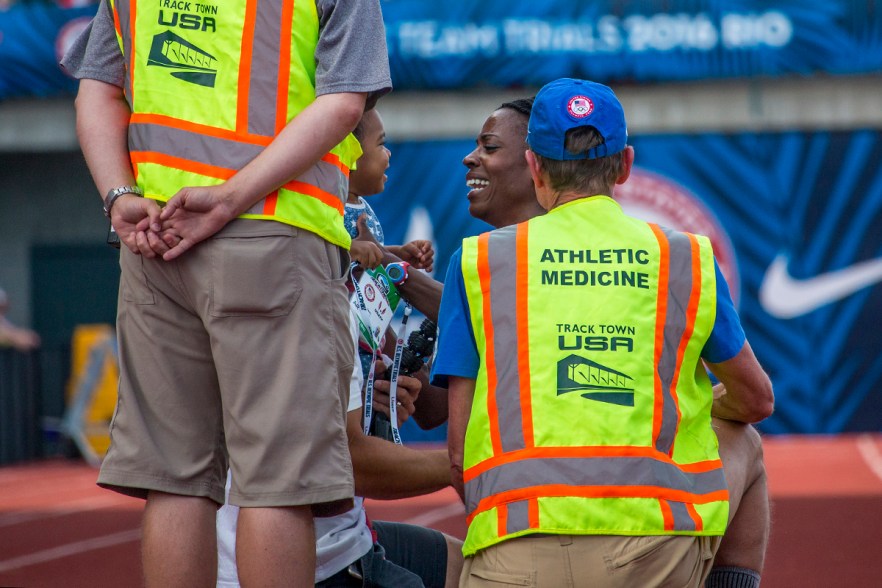 Asics’ runner and former Olympian Alysia Montano embraces her son after falling in the women’s 800 meter finals. Just before the final stretch, Montano collided with another runner and fell. Montano was unable to get up and complete the race. Day Four of the U.S. Olympic Trials Track and Field were held Monday at Hayward Field in Eugene, Ore. and will continue through July 10. Photo by Katie Pietzold