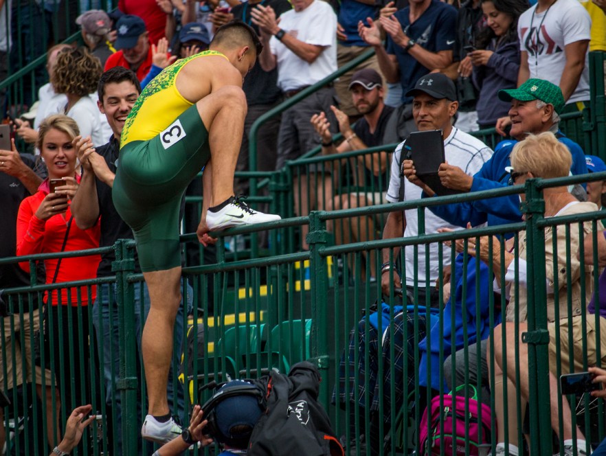 Oregon Duck Devon Allen completes one more hurdle as he jumps the fence of the stands to find his family after placing first in the finals of the men's 110 meter hurdles. Allen will head to Rio after running a 13.03. Day Nine of the U.S. Olympic Trials Track and Field continued on Saturday at Hayward Field in Eugene, Ore. and will continue through July 10. Photo by Katie Pietzold