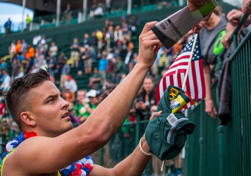 Oregon Duck Devon Allen signs autographs on his victory lap around Hayward Field after qualifying for Rio in the men's 110 meter hurdles. Allen placed first in 13.03. Nine of the U.S. Olympic Trials Track and Field continued on Saturday at Hayward Field in Eugene, Ore. and will continue through July 10. Photo by Katie Pietzold