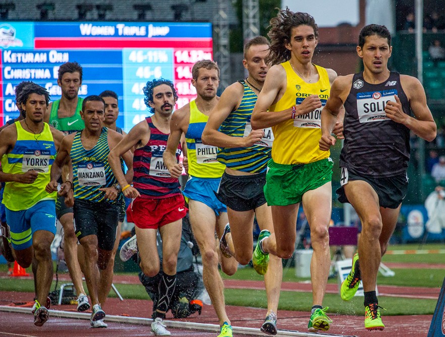 Runners compete in the prelims of the men’s 1,500 meter run as they get splashed with a downpour of rain. Day Seven of the U.S. Olympic Trials Track and Field were held Thursday at Hayward Field in Eugene, Ore. and will continue through July 10. Photo by Katie Pietzold