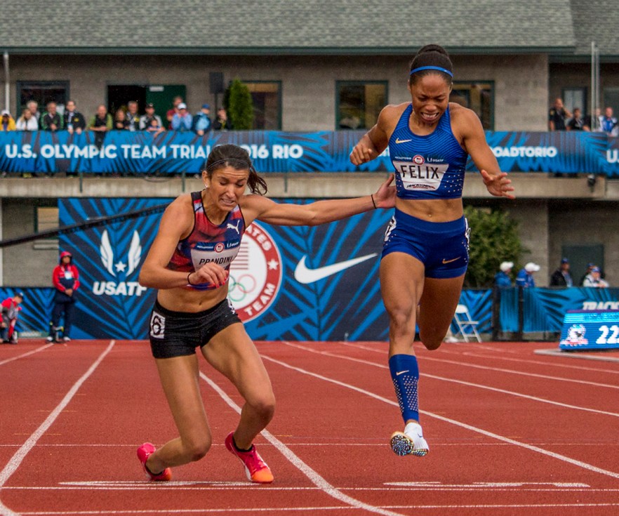 Puma’s Jenna Prandini falls at the finish line as Nike’s Allyson Felix leans in for the finish. Prandini placed third in 22.53 and Felix a close fourth in 22.54. Prandini will compete in Rio for Team USA.